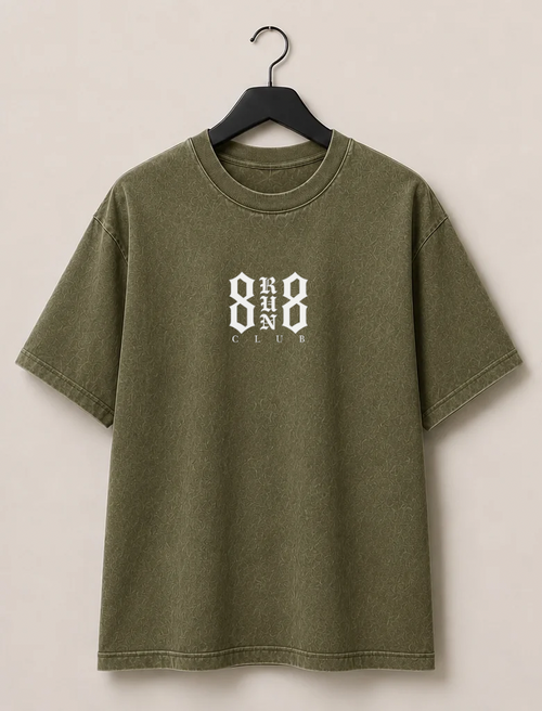 An olive green short-sleeve t-shirt shown from both front and back, hanging on black hangers against a light beige wall. The front features a small white graphic on the left chest, and the back features a large white graphic reading '8 RUN 8 CLUB'.